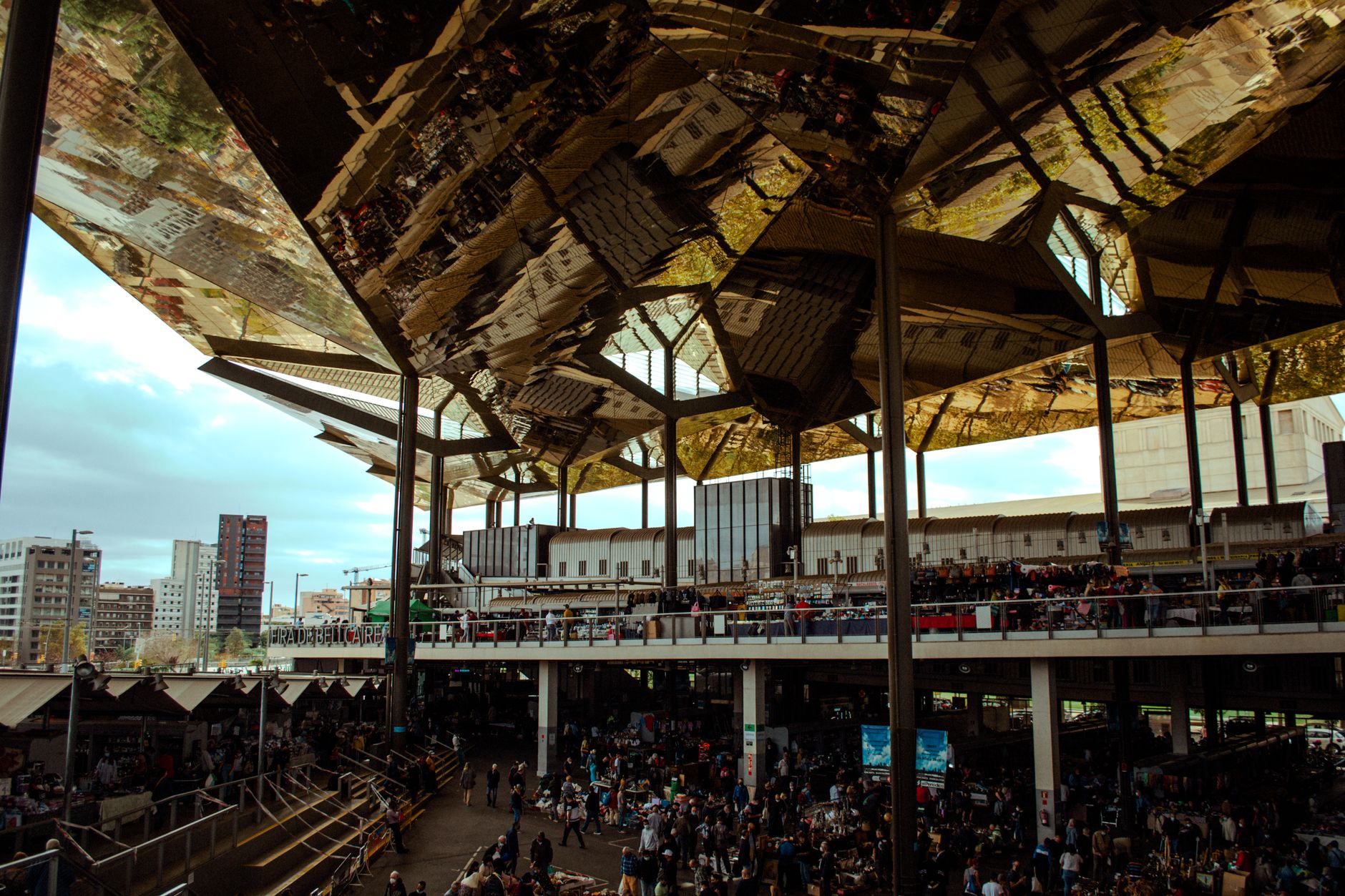 Urban market scene bustling with crowd under a striking reflective roof in a modern city. — AI Writers for Businesses: How Th