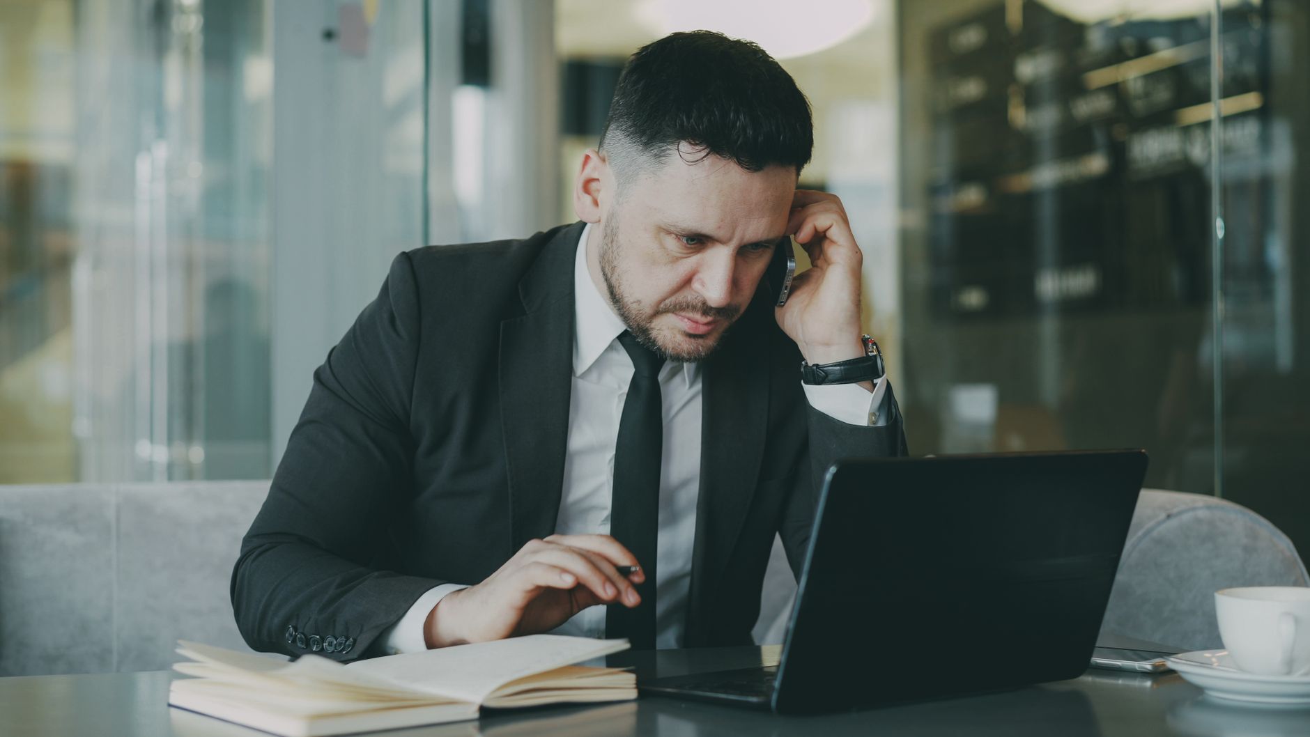 Focused businessman in suit multitasking on phone and laptop in modern office. — Maximizing Efficiency in PP Recycling: Best